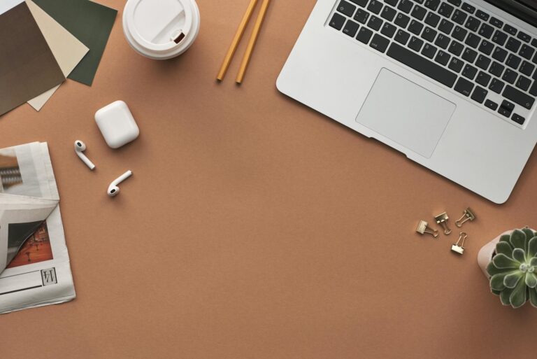 flat lay of a modern workspace with a laptop airpods and coffee for productivity. 3184464 scaled